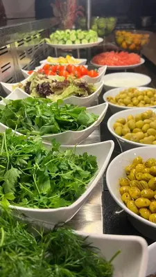 a buffet filled with bowls of vegetables and other foods at Hilton Garden Inn Corlu in Corlu