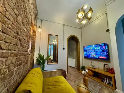 a living room with a couch and a tv at Mansion Istanbulite in Istanbul
