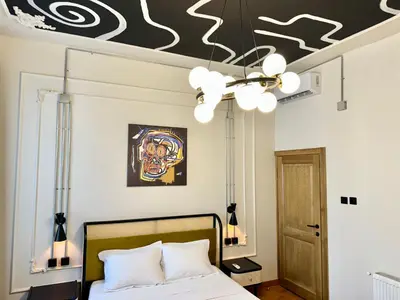 a bedroom with a bed and a ceiling with a chandelier at Mansion Istanbulite in Istanbul