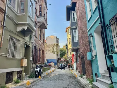 an alley with buildings and people walking down a street at Mansion Istanbulite in Istanbul