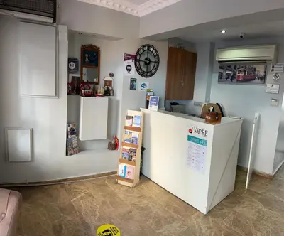 a kitchen with a refrigerator and a clock on the wall at Nacre Boutique Residence in Istanbul