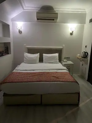 a bed with two pillows and avertisement at Nacre Boutique Residence in Istanbul