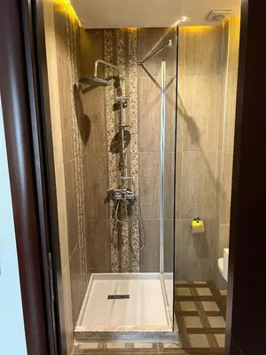 a shower with a glass door in a bathroom at Nacre Boutique Residence in Istanbul