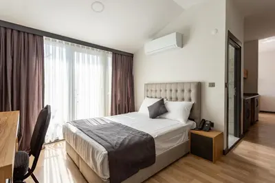 a bedroom with a bed and a large window at Atm Suit Otel in Istanbul
