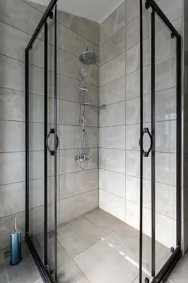 a shower with a glass door in a bathroom at Atm Suit Otel in Istanbul