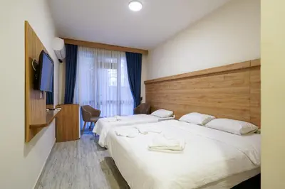 a hotel room with two beds with towels on them at Askoroz Otel İzmit in Izmit
