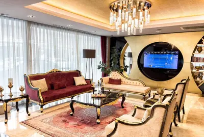 a living room with a couch and a tv at The Conforium Hotel İstanbul in Istanbul