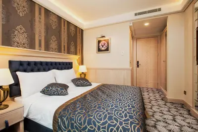 a hotel room with a bed with two pillows at The Conforium Hotel İstanbul in Istanbul
