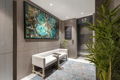 a lobby with a white couch and a painting on the wall at Lunet Old City Hotel in Istanbul