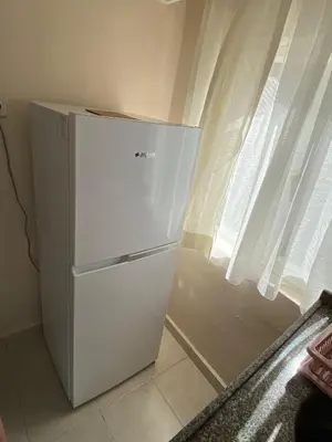 a white refrigerator in a kitchen next to a window at ilkim&derin suite in Istanbul