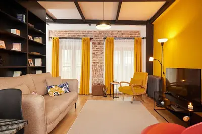 a living room with a couch and a television at Stunning Apartment at Unbeatable Location in Istanbul