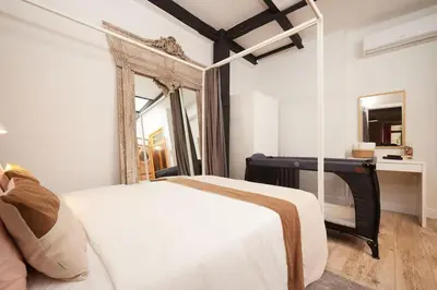 a bedroom with a white bed and a mirror at Stunning 2BR 1 Min Metro&Galata in Istanbul