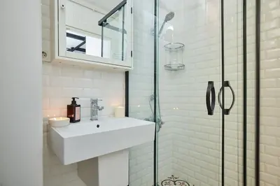 a bathroom with a sink and a glass shower at Stunning 2BR 1 Min Metro&Galata in Istanbul