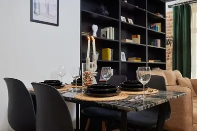 a dining room table with chairs and wine glasses at Stunning 2BR 1 Min Metro&Galata in Istanbul