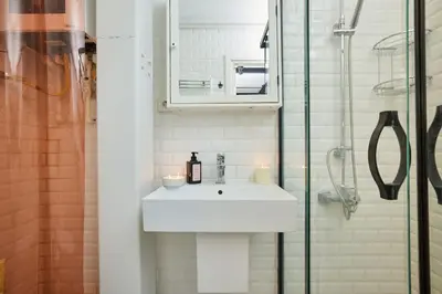 a bathroom with a sink and a glass shower at Modern 2BR Apt Galata-Taksim Area Near Metro in Istanbul