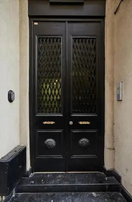 a black door on a building with steps at Modern 2BR Apt Galata-Taksim Area Near Metro in Istanbul