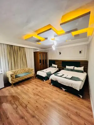 a hotel room with two beds and a couch at Pembe Köşk Old City Center in Istanbul