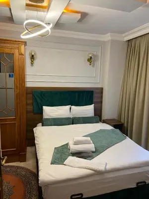 a bedroom with a bed with towels on it at Pembe Köşk Old City Center in Istanbul
