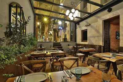a restaurant with wooden tables and chairs in a room at Taxim Lounge Hotel Special Category in Istanbul