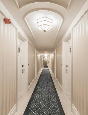 a hallway with a ceiling with a black carpet at Metropolitan Hotels Taksim in Istanbul