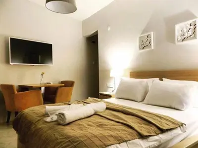 a bedroom with a large bed and a table with chairs at NO PROBLEM OTEL Pansiyon in Tekirdag
