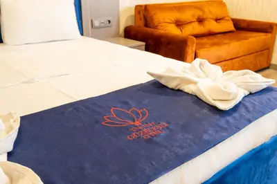 a bed with a blue towel on top of it at The Port Güzelyalı in Pendik