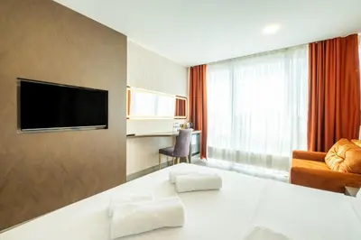 a hotel room with a bed and a flat screen tv at The Port Güzelyalı in Pendik