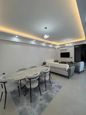 a living room with a table and chairs and a couch at Havuzlu Villa-Kartepe in Masukiye