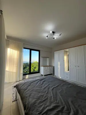 a large bedroom with a large bed and a large window at Havuzlu Villa-Kartepe in Masukiye