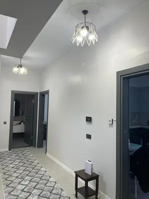 a living room with two lights and a table at Havuzlu Villa-Kartepe in Masukiye