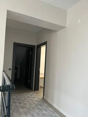 an empty room with a white wall and an open door at Havuzlu Villa-Kartepe in Masukiye