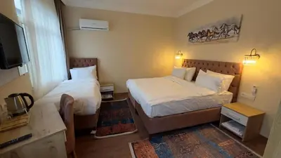 a hotel room with two beds and a television at Albatros suite in Istanbul