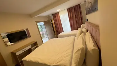 a hotel room with a bed and a flat screen tv at Albatros suite in Istanbul