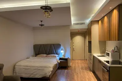 a bedroom with a bed and a kitchen with a microwave at Low Price Luxury Apartment Perfect for An Amazing stay In ISTANBUL in Istanbul