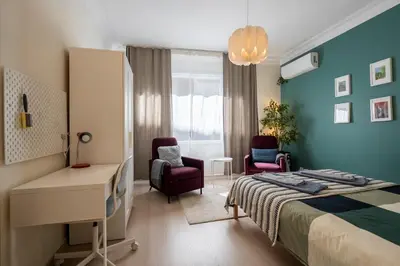 a bedroom with a bed and a desk and chairs at sevim suites Nişantaşı Center in Istanbul