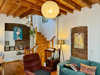 a living room with a blue couch and stairs at The Wooden 17 in Istanbul