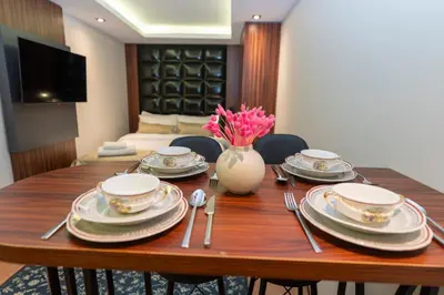 a dining room table with plates and a vase of flowers at THE MUA LUXURY HOMEs in Istanbul