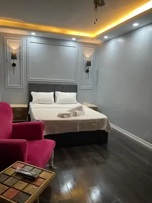 a bedroom with a bed and a couch and a table at Kıyı Butik Otel in Mimarsinan