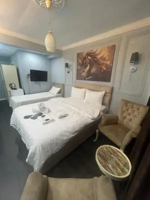 a hotel room with a bed and a chair at Kıyı Butik Otel in Mimarsinan