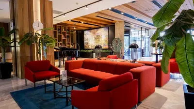 a lobby with red couches and a table and chairs at Dosso Dossi Hotels & SPA Downtown in Istanbul