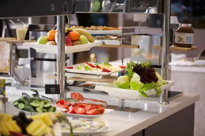 a buffet line with plates of fruits and vegetables at Dosso Dossi Hotels & SPA Downtown in Istanbul