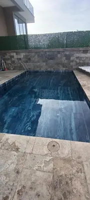 a swimming pool with blue water in a house at Naturel villaları in Orhangazi
