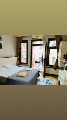 two beds in a room with two windows at Yaman suit in Istanbul