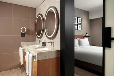 a bathroom with a sink and two mirrors at Four Points by Sheraton Istanbul Pendik in Istanbul