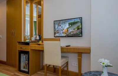 a room with a desk with a television on a wall at Bizim Hotel in Istanbul