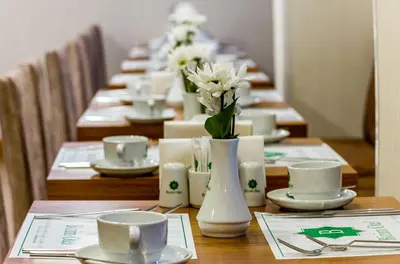 a long table with plates and cups and flowers on it at Bizim Hotel in Istanbul