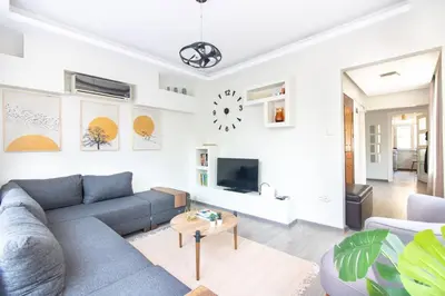 a living room with a couch and a tv at Pretty Corner Flat with Abundant Light in Kadikoy in Istanbul