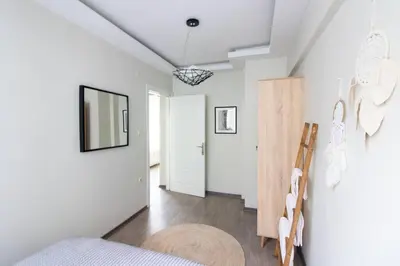 a bedroom with a bed and a mirror on the wall at Pretty Corner Flat with Abundant Light in Kadikoy in Istanbul