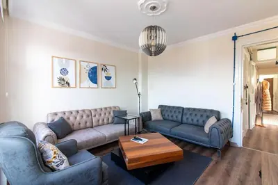 a living room with two couches and a coffee table at Soft and Historic 3BR Home w Iconic Haydarpasa View in Istanbul