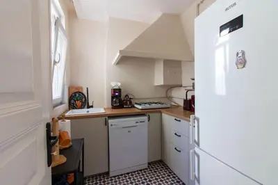 a small kitchen with white cabinets and a window at Soft and Historic 3BR Home w Iconic Haydarpasa View in Istanbul